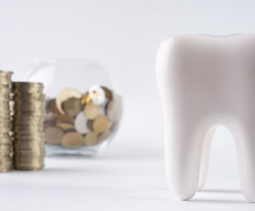 money next to a tooth