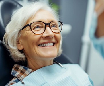 Older female patient talking with dentist